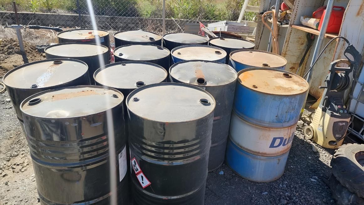 Bunch of Barrels Are Stacked on Top of Each Other — Beehive Property Maintenance in Blackwater, QLD