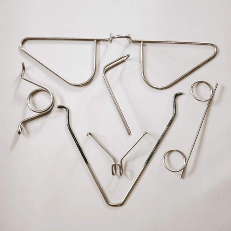A bunch of metal objects are laying on a white surface