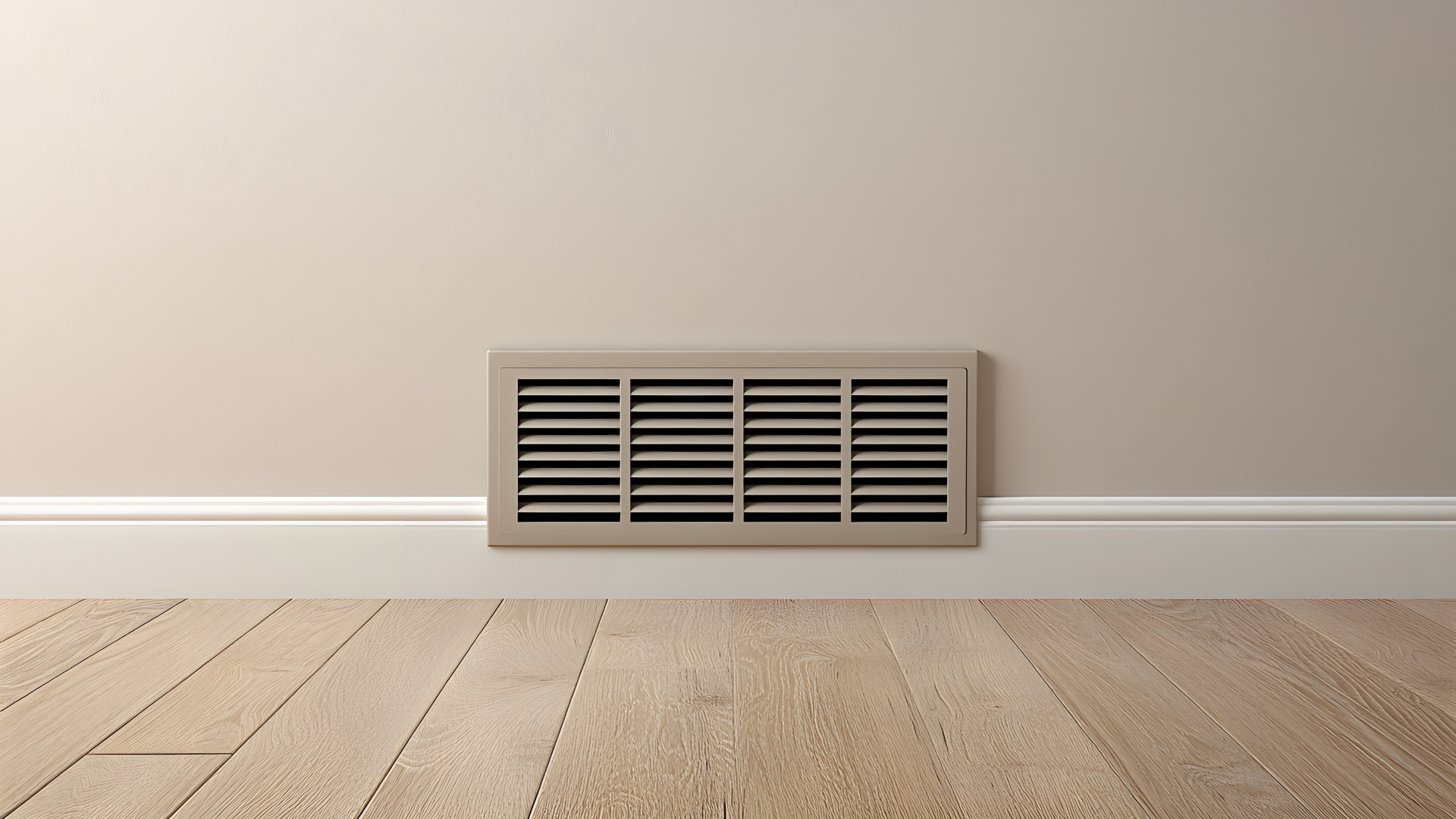 Wall-mounted air vent on a beige wall above a light wood floor.