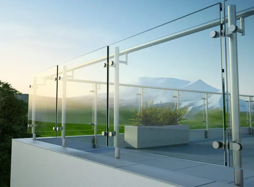 A balcony with a glass railing and a mountain in the background.