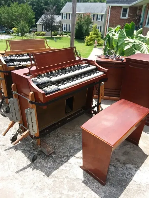 A Group of Organs are sitting on a Patio in front of a House - Fredericksburg, VA - 	McKenzie Wills Hammond Organ Repair