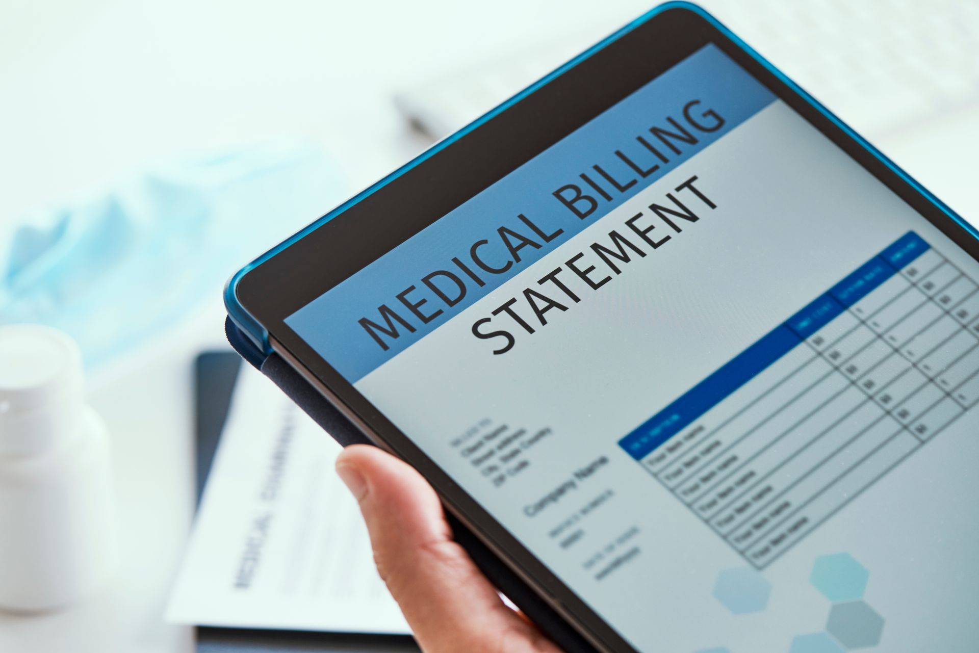 A doctor checking a billing statement on a tablet. A doctor checking a billing statement on a tablet.