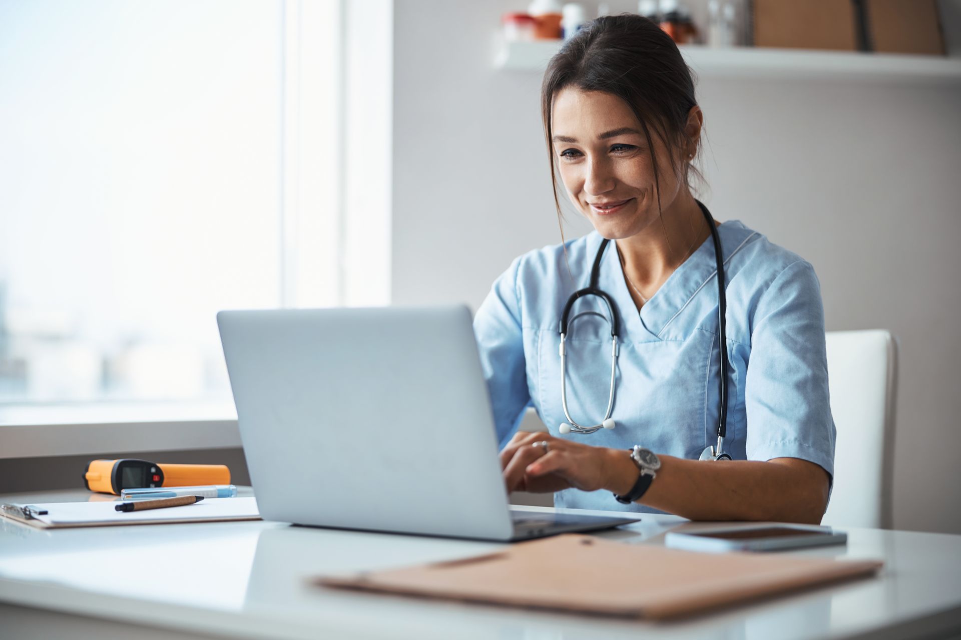 A doctor is using a computer.