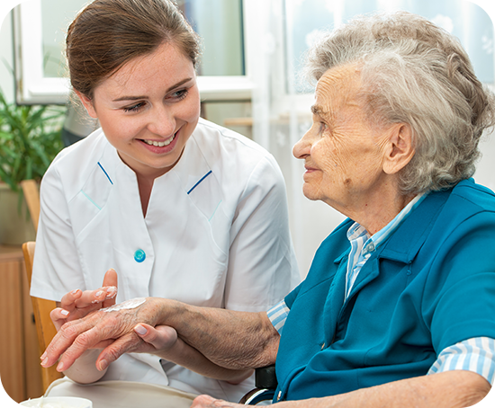 A nurse with two old person outside of the center