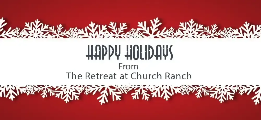 A red background with white snowflakes and the words happy holidays from the retreat at church ranch