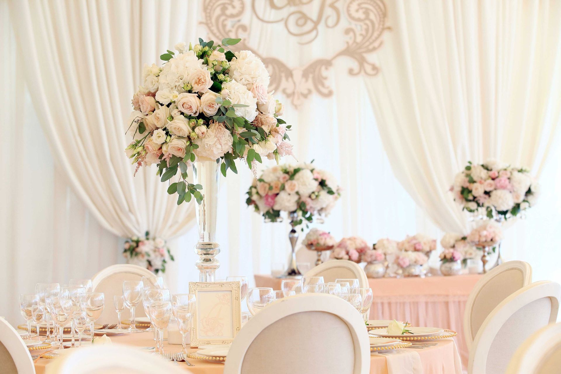 Pink and purple floral bouquet with monarch butterfly decoration, on a wooden table.