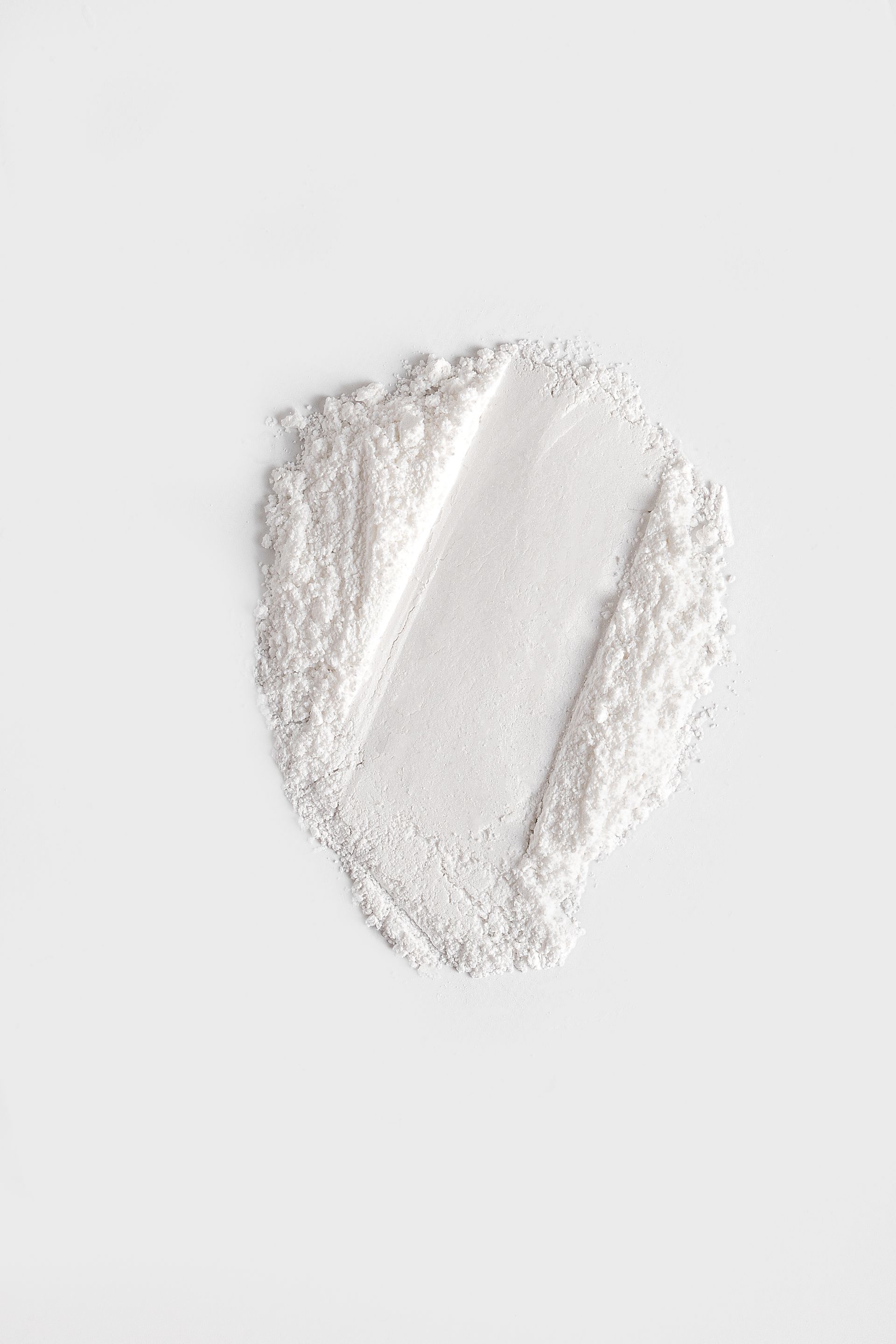 White shimmery powder swatch against a white background.