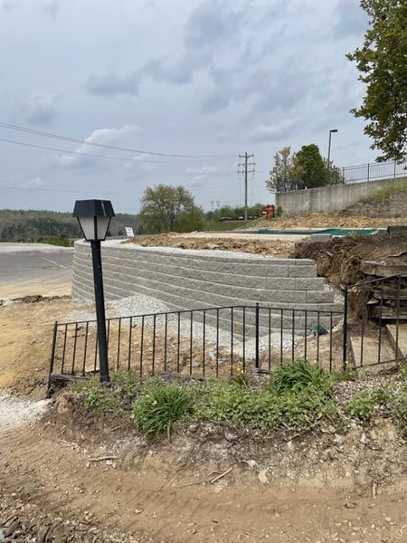 A brick wall is being built next to a street light.