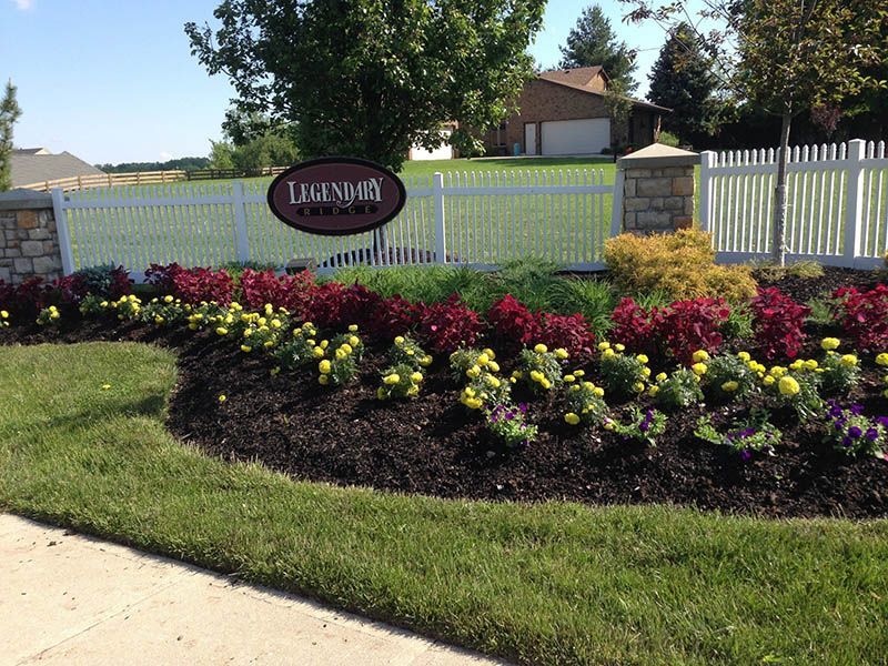 A sign that says lakeside is surrounded by flowers