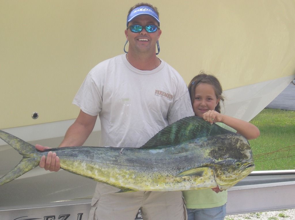 a man and a little girl holding a large fish
