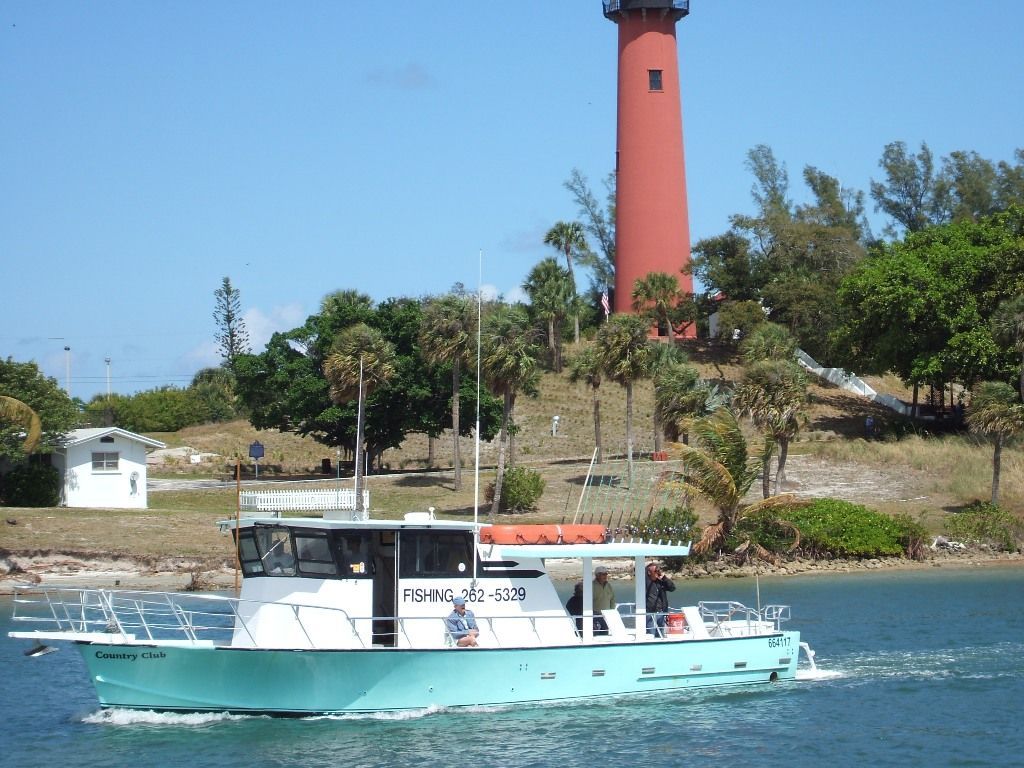 A boat with a red lighthouse in the background