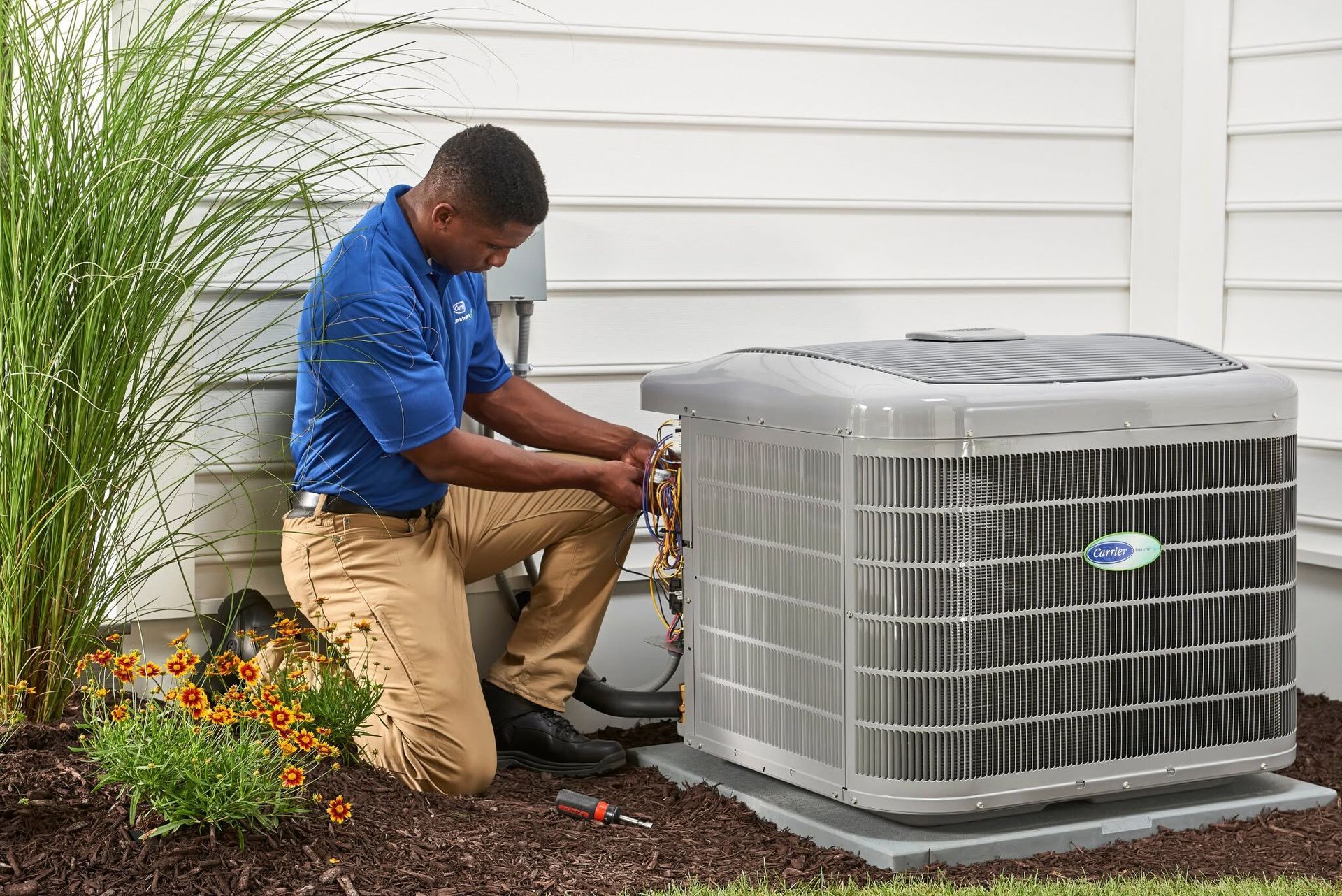 HVAC maintenance technician servicing a home heating system