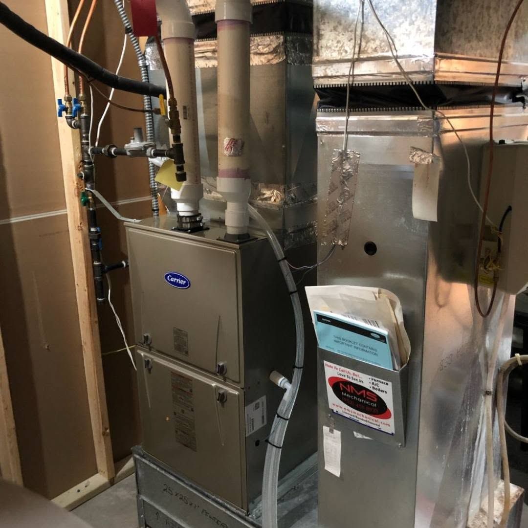 Basement furnace and HVAC system with metal ductwork and a humidifier unit.