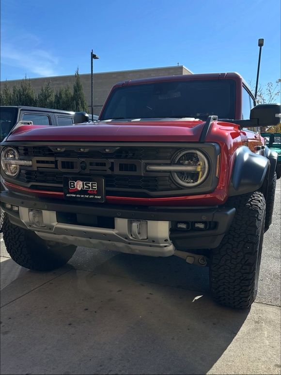 A red Ford Bronco Raptor parked on an asphalt — 4 x 4 shops near me
