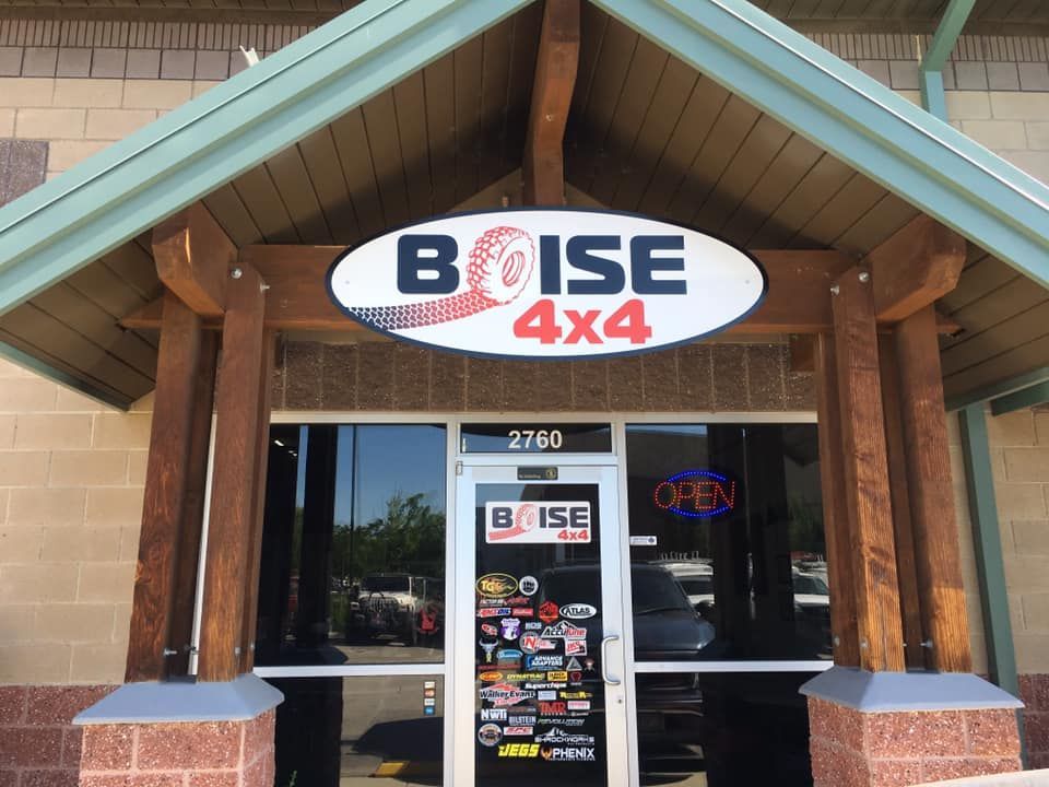 The storefront of Boise 4x4, featuring a branded oval sign above the glass door, address 2760, and stickers on the door.