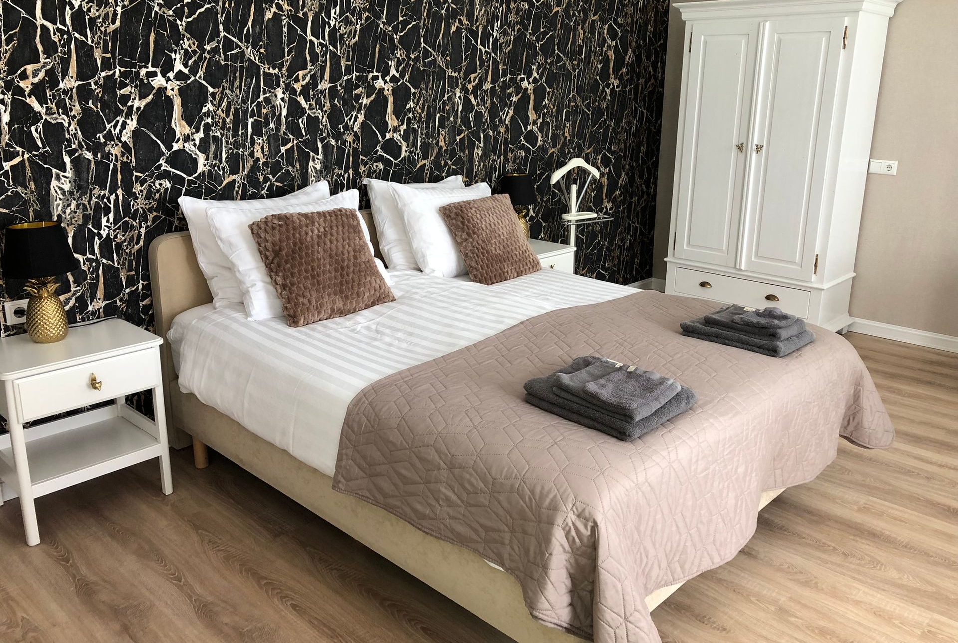 Een slaapkamer met een groot bed en een nachtkastje