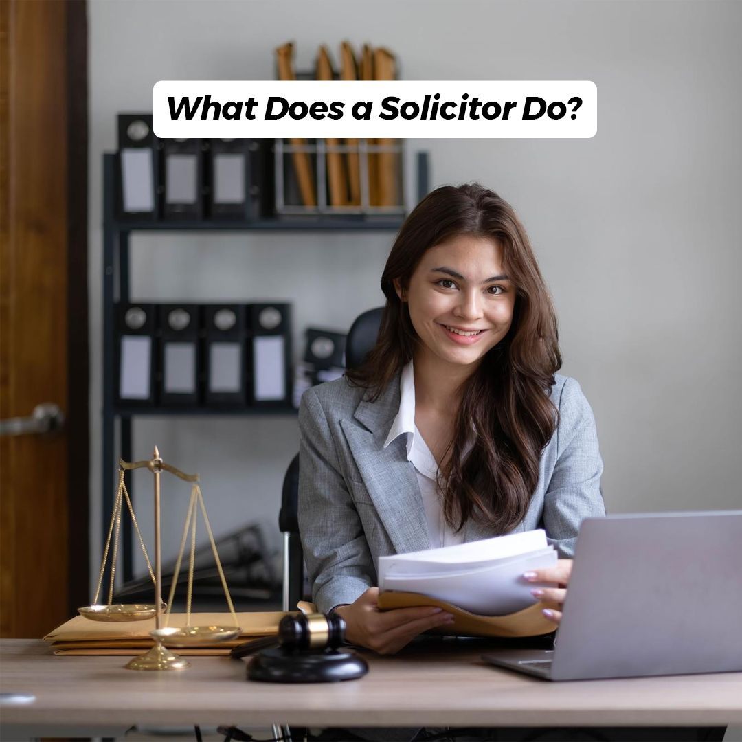Woman solicitor at a desk with a laptop and legal scale; text above reads 