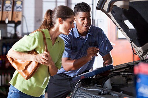 Women Checking Car Engine — Arlington, TX — High Tech Transmission Specialists