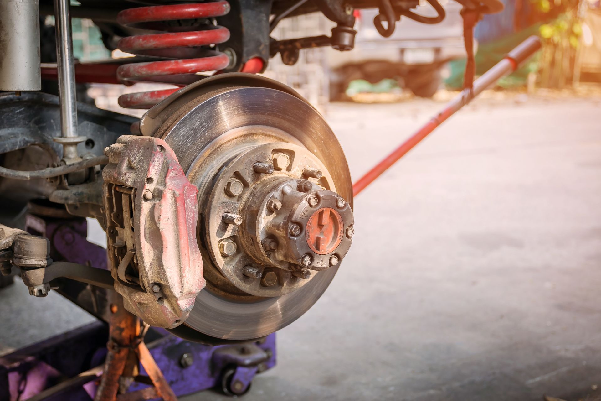 Car brake assembly, rotor, caliper, suspension details. Mechanic's work on wheel.