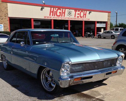 Old fashion car in front of the high tech store