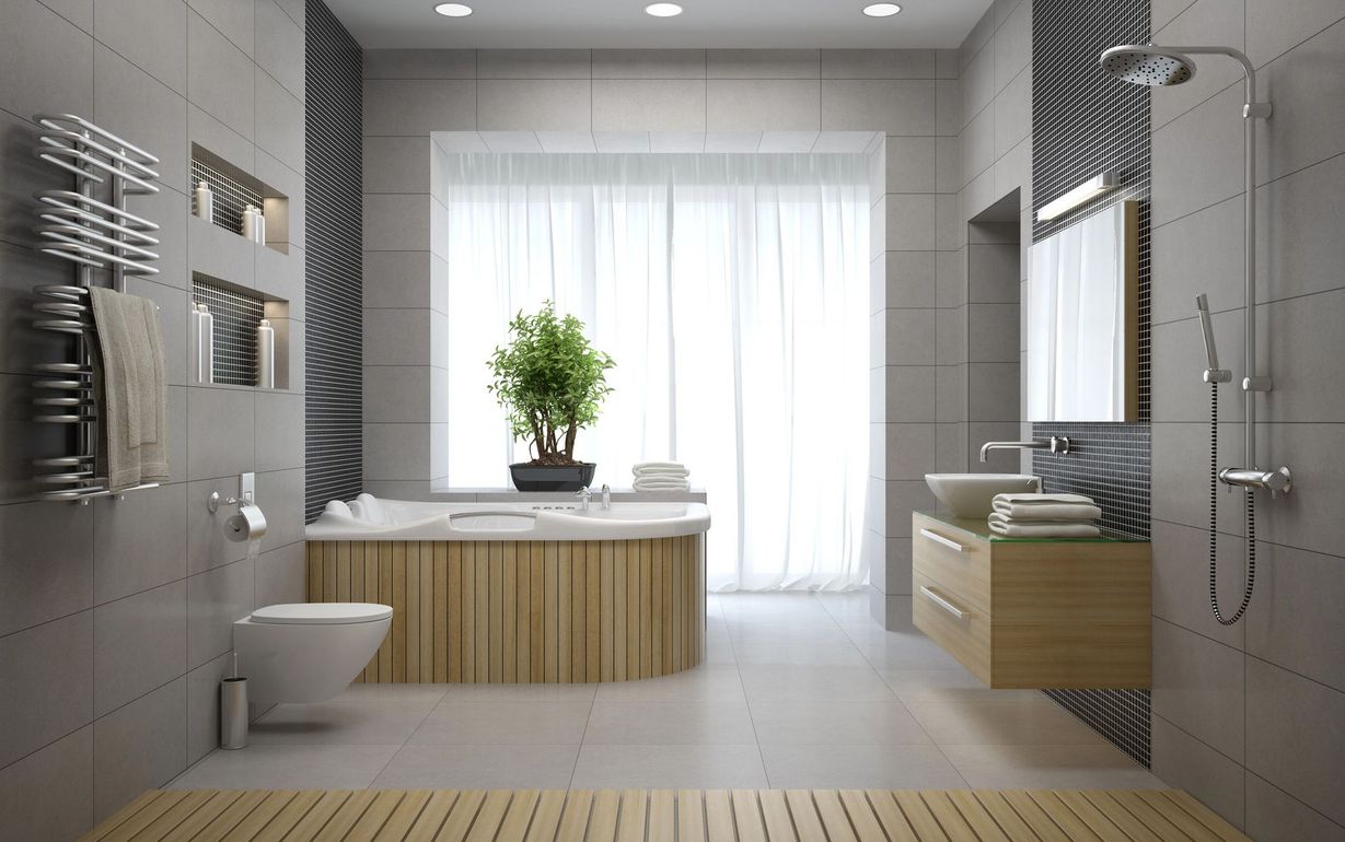 Bagno moderno con vasca freestanding, doccia in vetro, lavabo a parete e pianta in vaso accanto a una finestra luminosa.