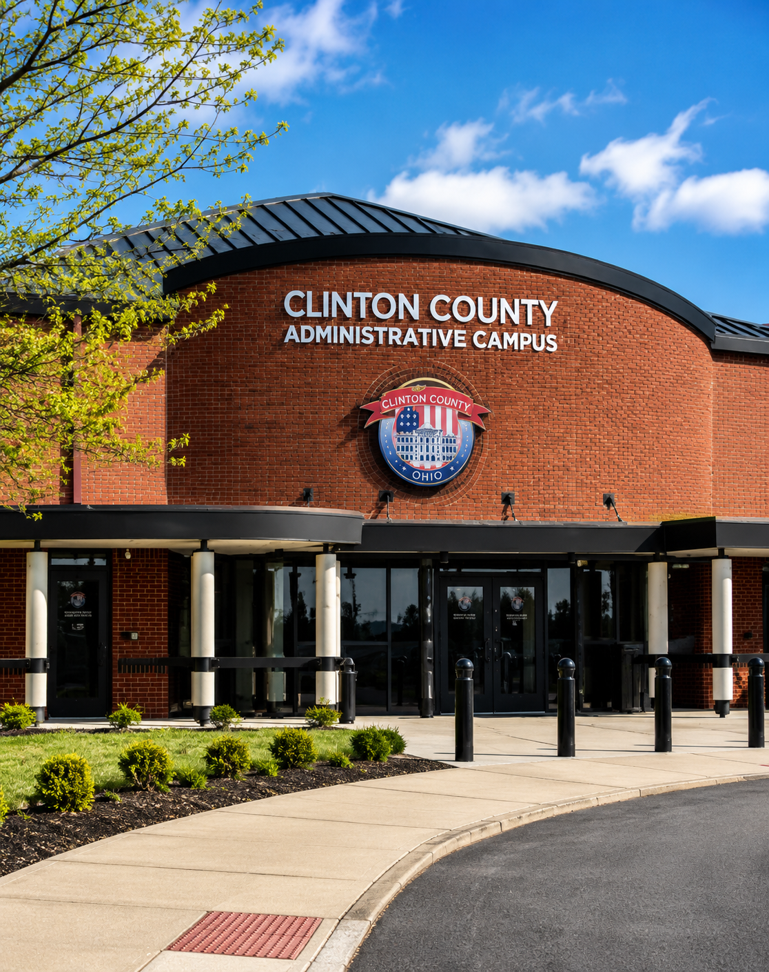Clinton County Administrative Campus brick building with glass entrance and blue sky