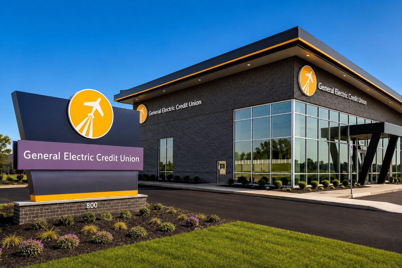 General Electric Credit Union building exterior with purple sign and glass entrance under a blue sky