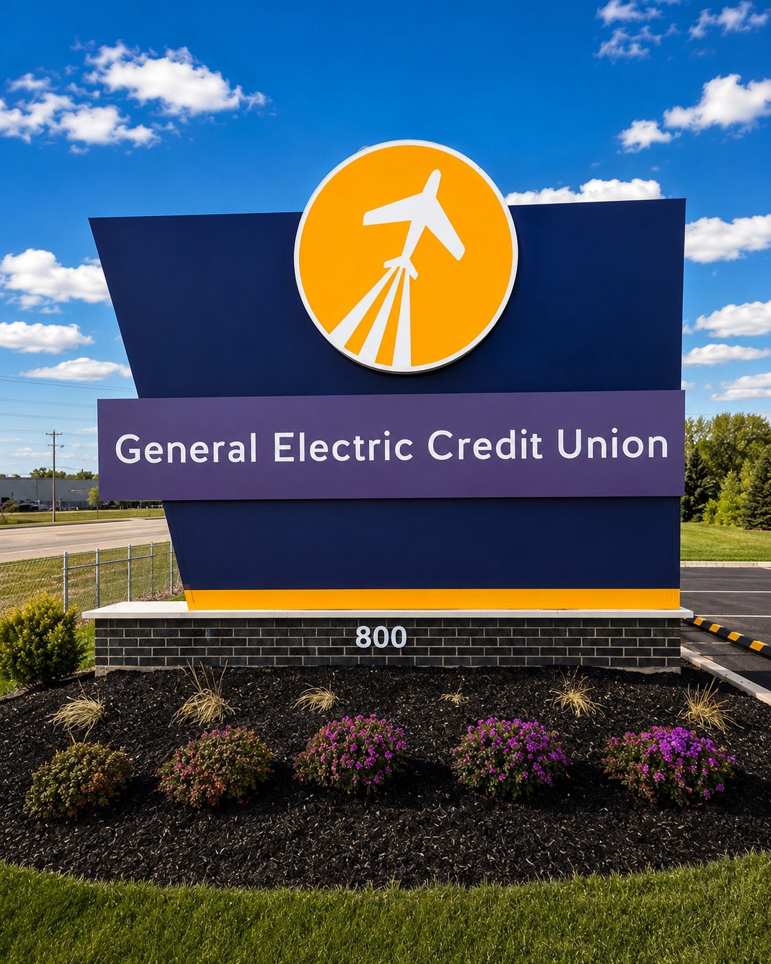 General Electric Credit Union roadside sign with orange logo on a blue and purple monument