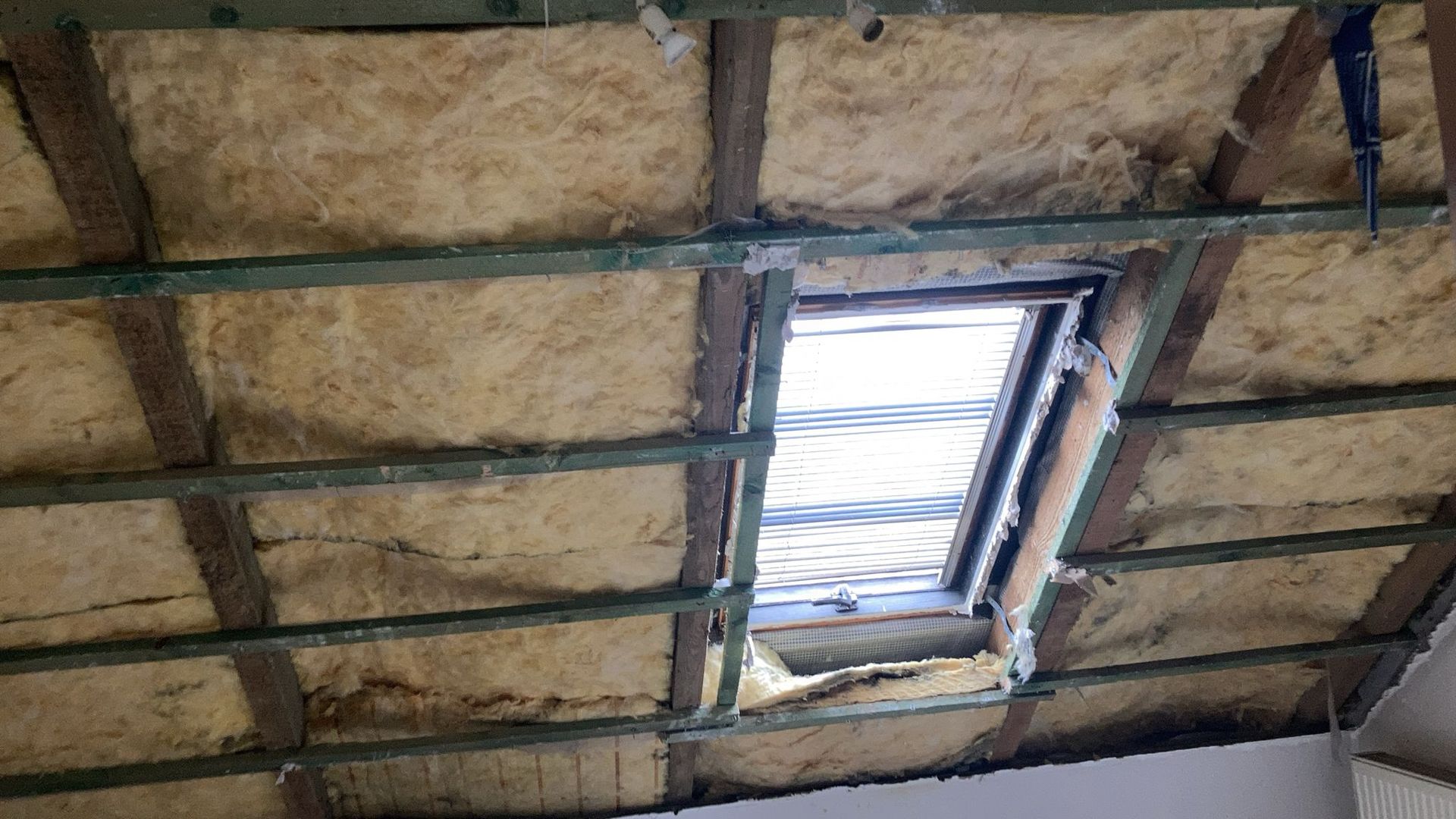 A ceiling with a window in the middle of it.
