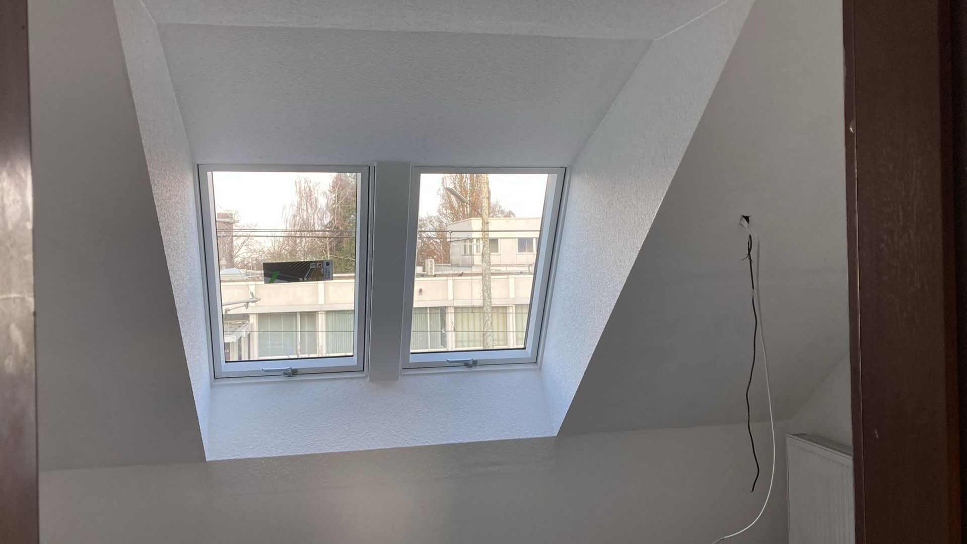 There is a skylight in the ceiling of a room.