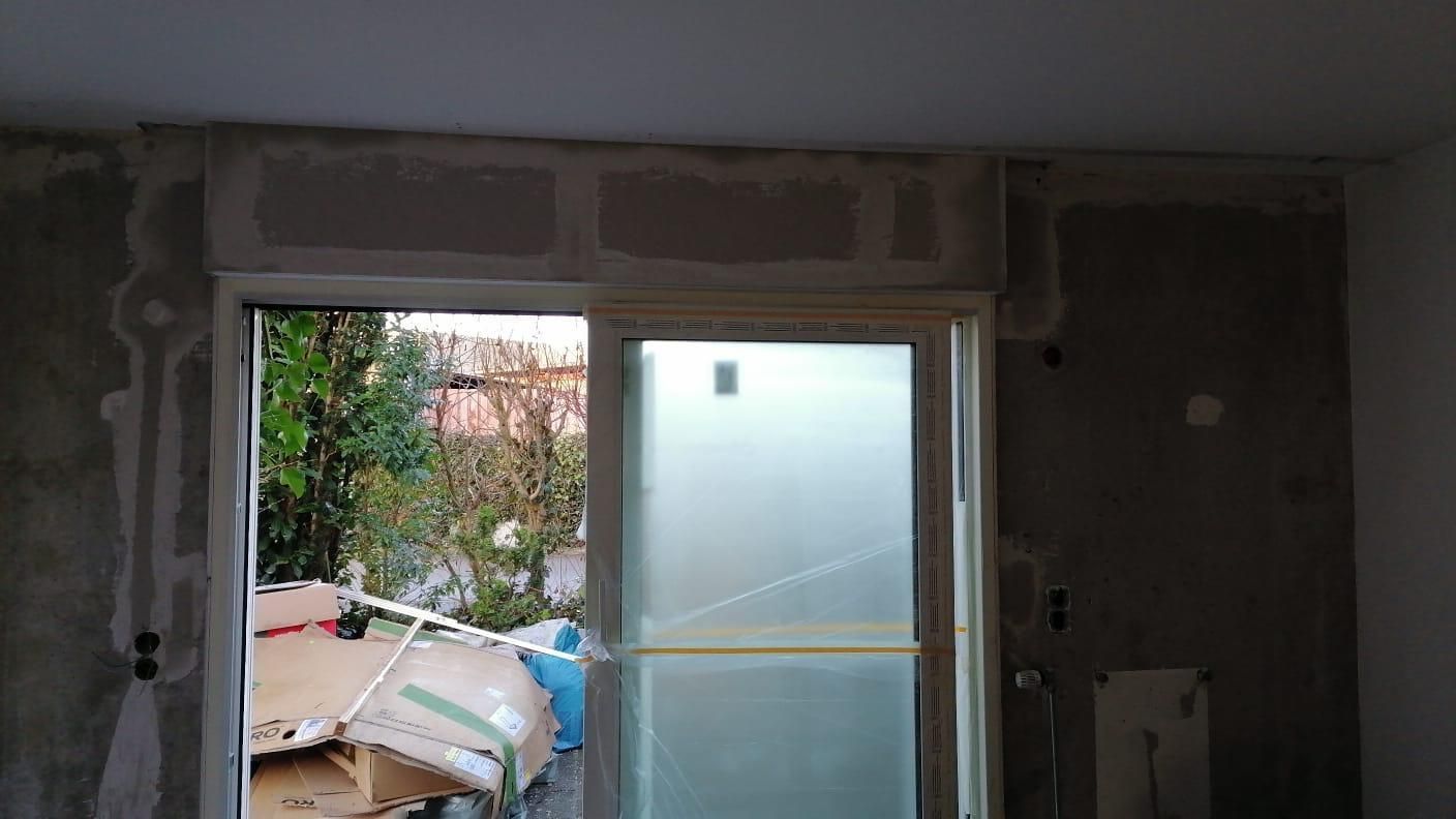 A room with a sliding glass door and a window.
