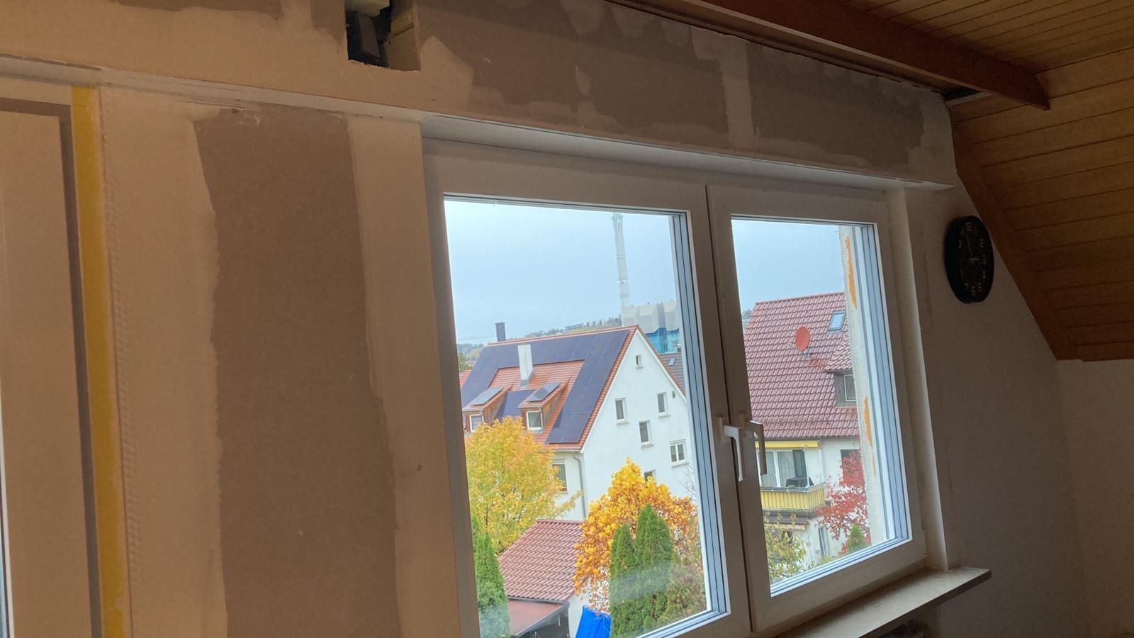 A room with a window and a view of a city.