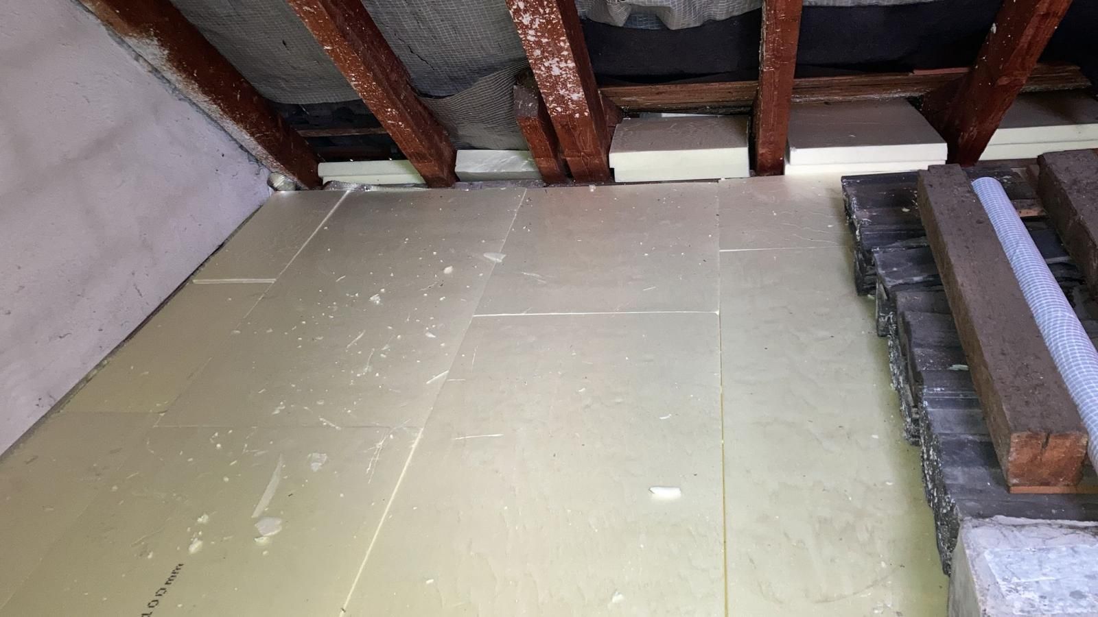 A room with a wooden ceiling and a wooden floor.