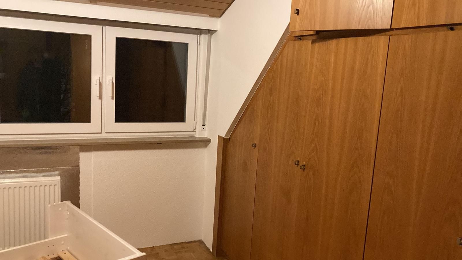 A room with wooden cabinets and a window.