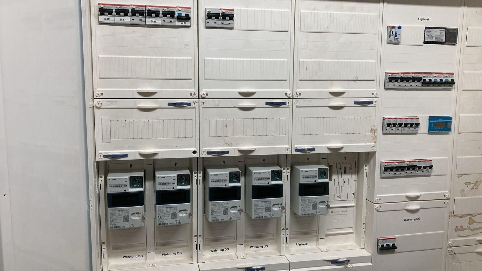A wall with a bunch of electrical boxes on it.