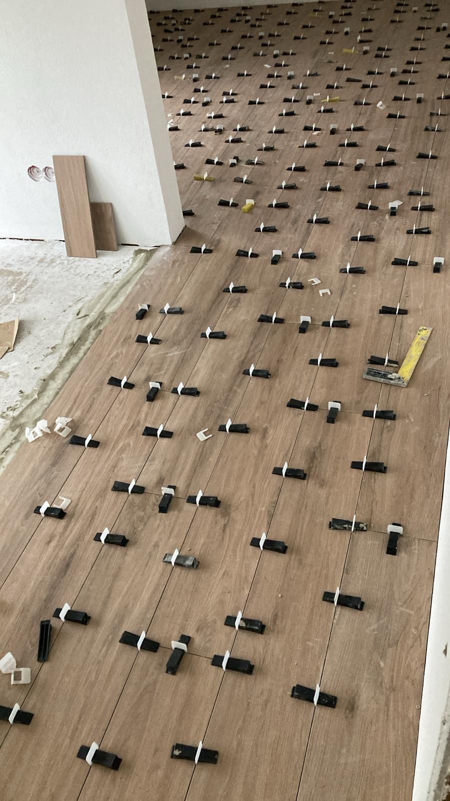 A wooden floor with a lot of tiles on it.