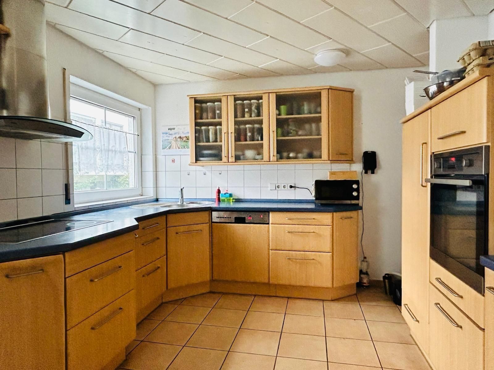 A kitchen with wooden cabinets and stainless steel appliances