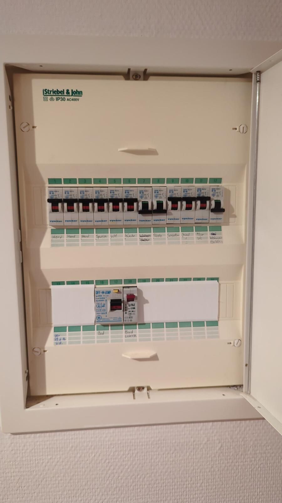 A white electrical box is sitting on a white wall.