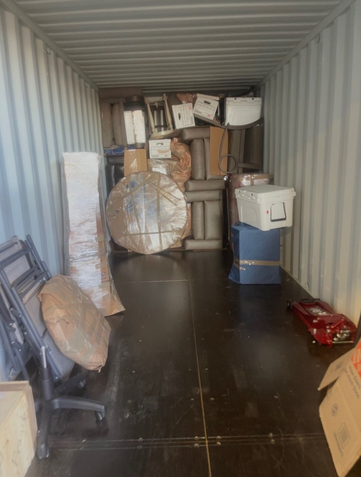Stacked wooden crates in a warehouse, filling the space, ready for transport or storage.