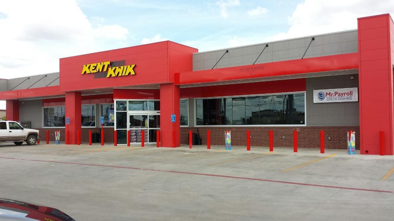 Kmart storefront with red facade and parking lot in front