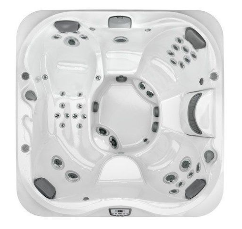 Top-down view of a white multi-seat hot tub with built-in jets and headrests
