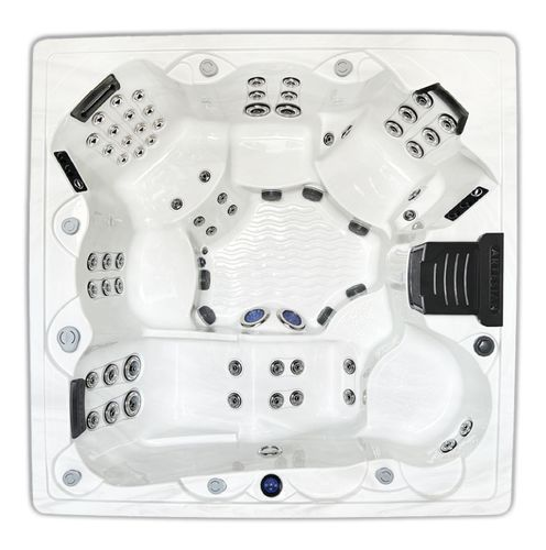 Top view of a white hot tub with multiple black massage jets and molded seats