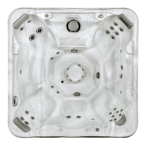 Top view of a white acrylic hot tub with multiple jet nozzles and built-in seats