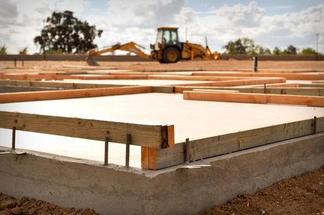 a construction site with a bulldozer in the background