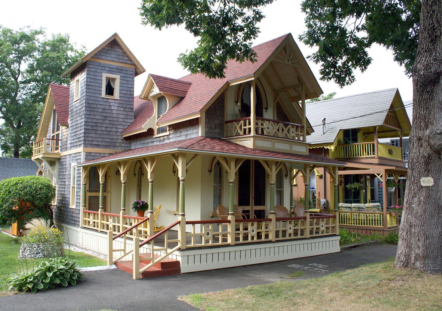 a large house with a porch and a clock tower