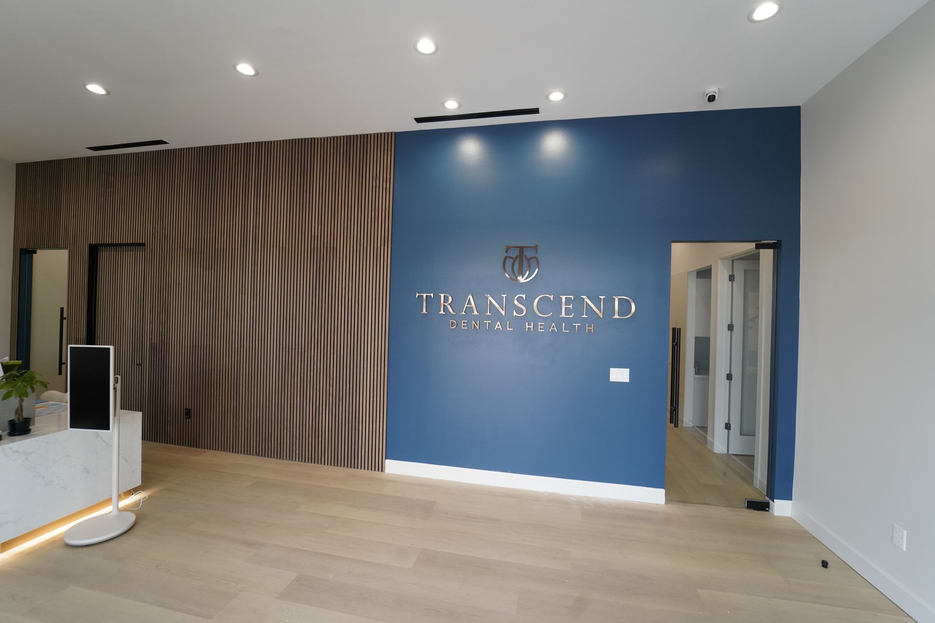 A dental office with a waiting room and a reception desk.