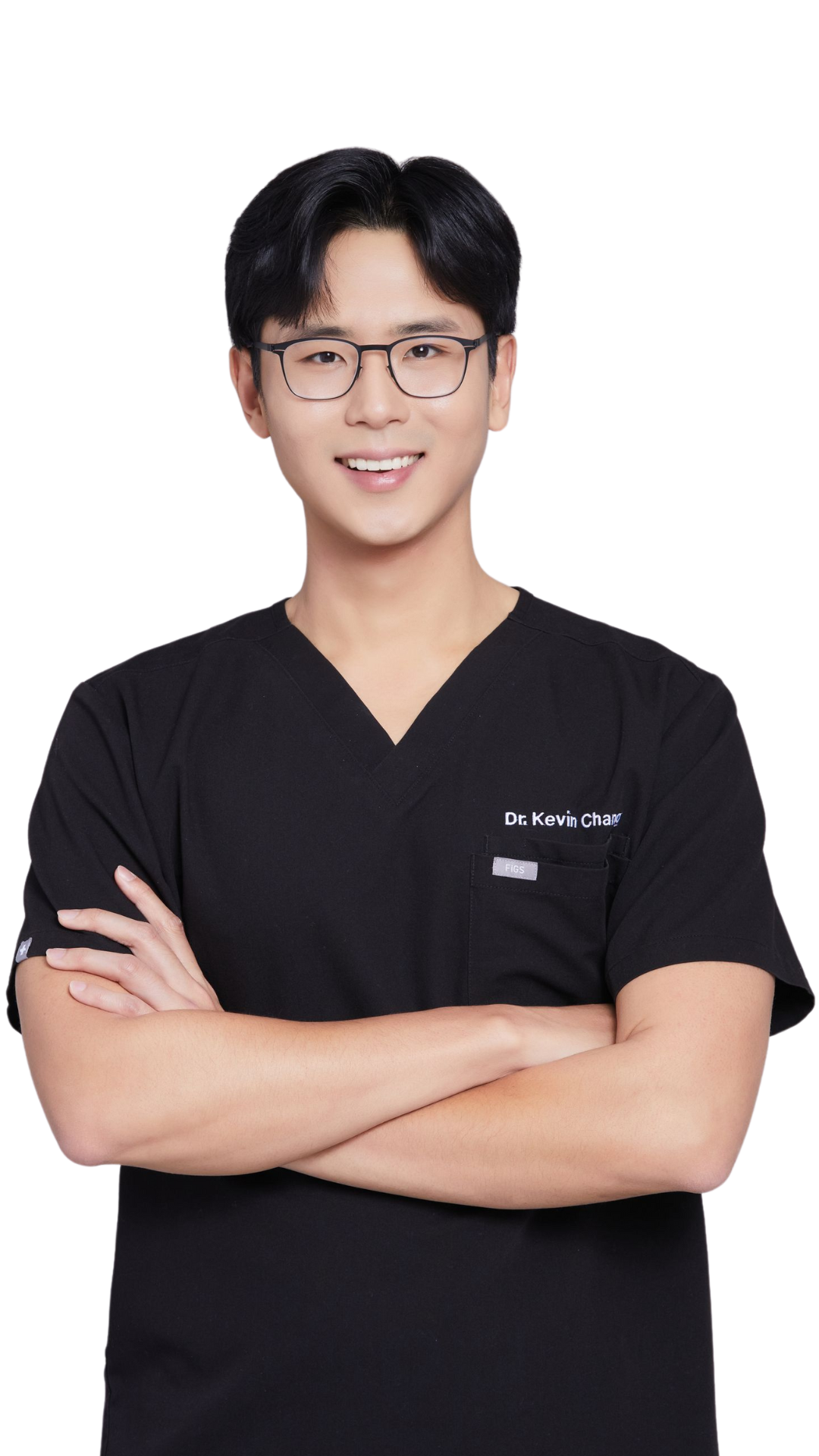 A young man wearing glasses and a black scrub top is standing with his arms crossed.