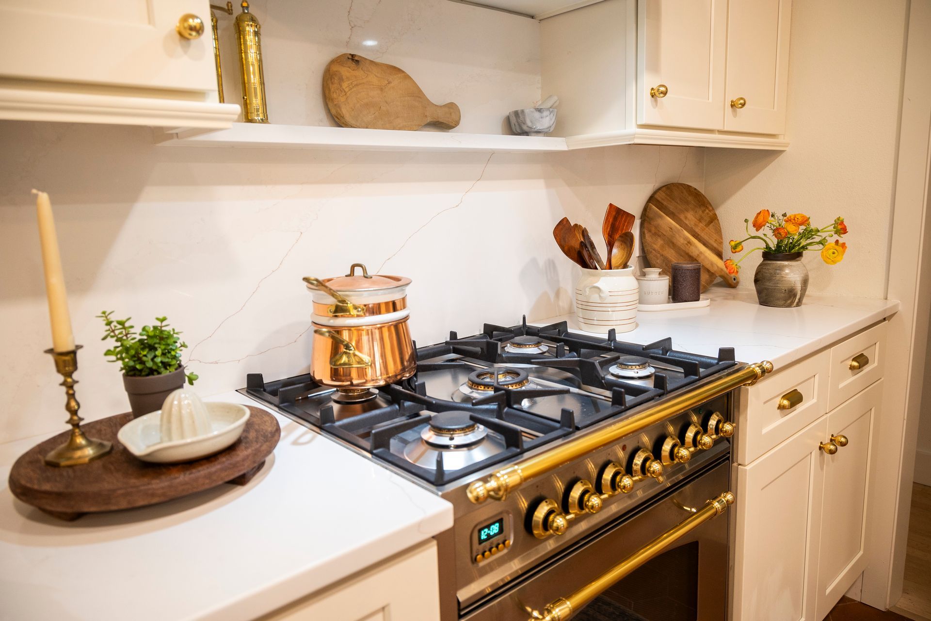 A kitchen with a stove top oven and pots and pans on it.