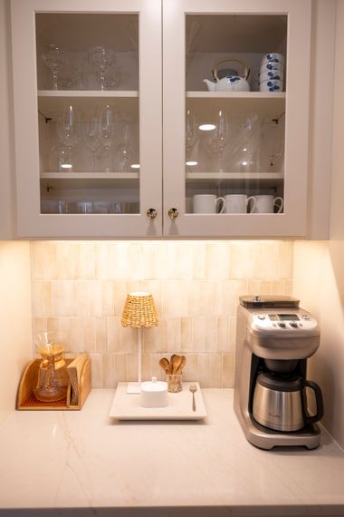 A coffee maker is sitting on a counter in a kitchen.