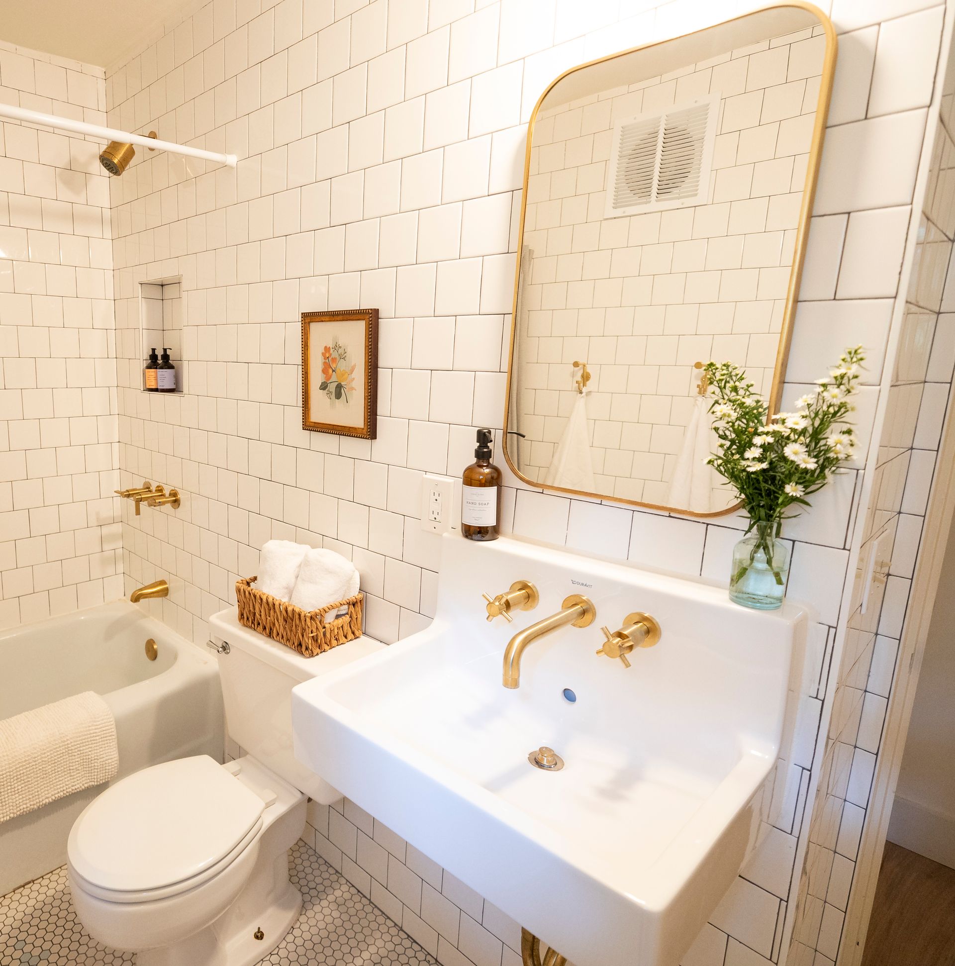 A bathroom with a toilet a sink and a mirror